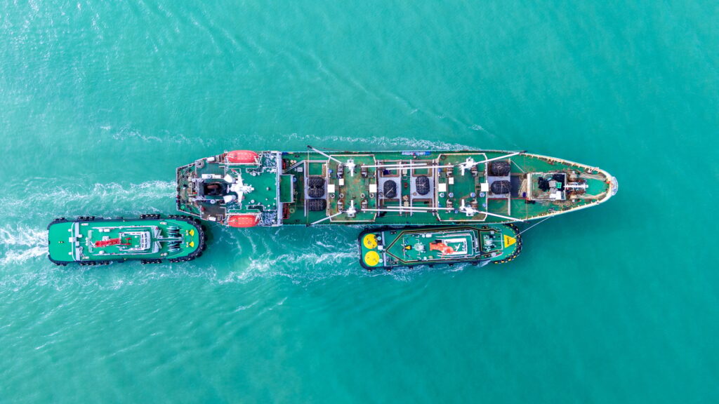 Cargo Ship was pulling by Tugboat go to Maintenance port. cargo ship import export to