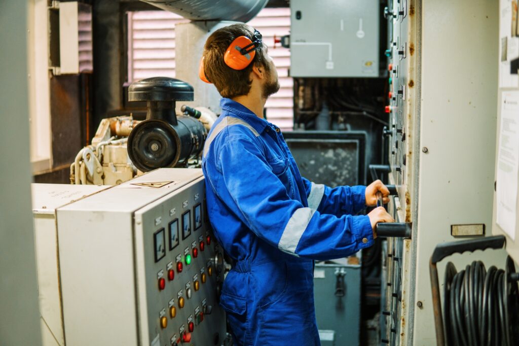 Marine engineer inspecting ship's engine or generators