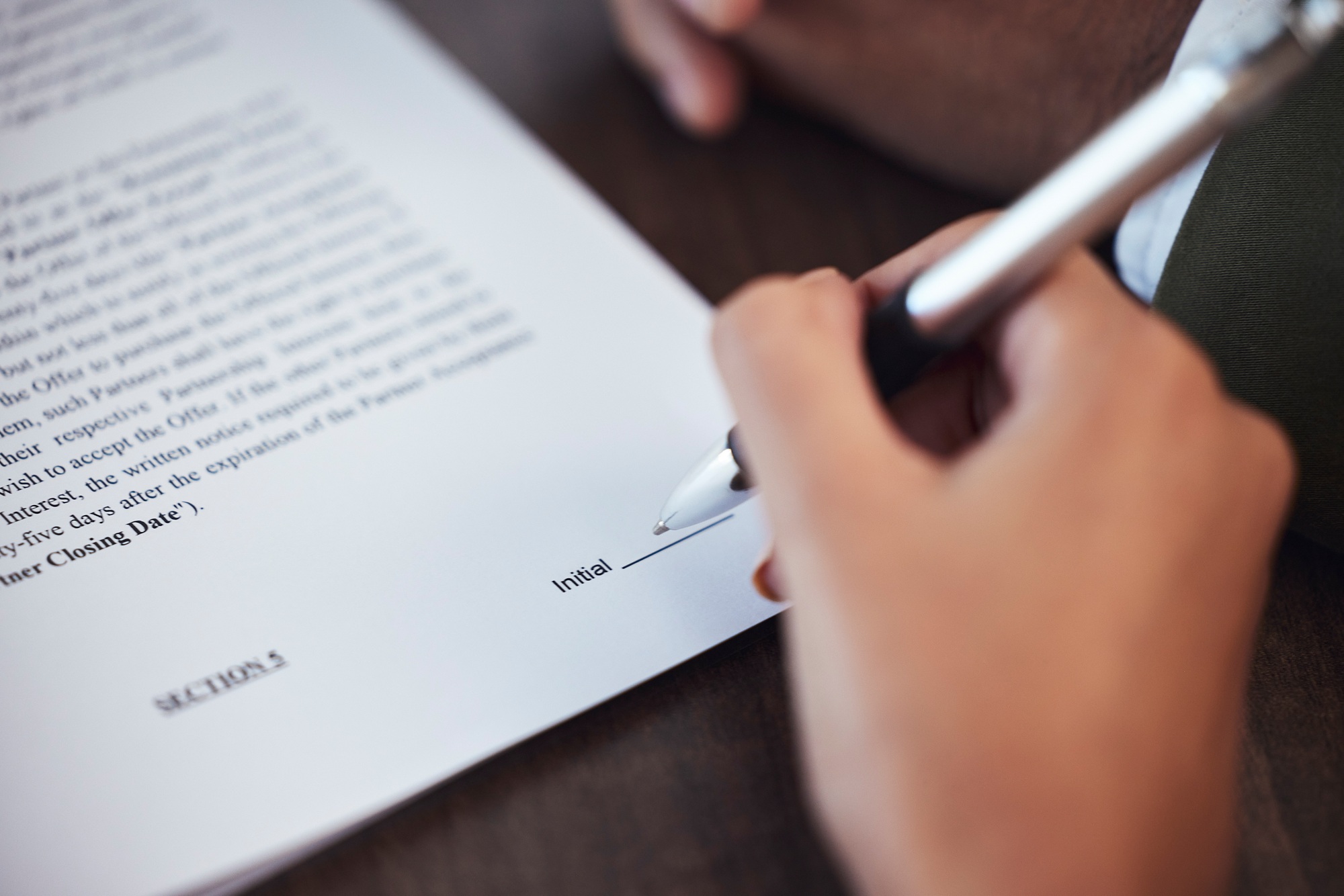 Sign contract, hand and pen with agreement, legal document and hiring with employment paperwork and